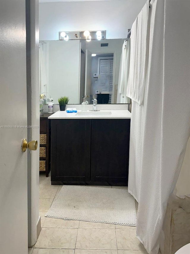 bathroom featuring vanity and tile patterned flooring