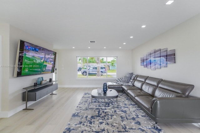 living room with baseboards, visible vents, wood finished floors, and recessed lighting