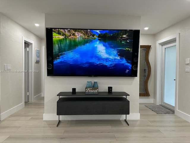 home theater room featuring baseboards, wood finished floors, and recessed lighting