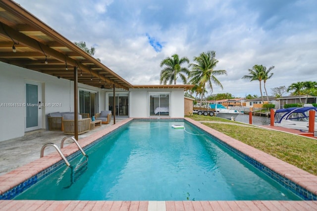outdoor pool with a patio area