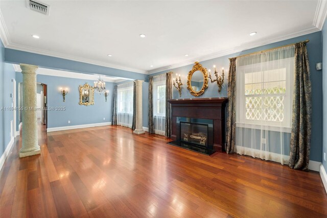 unfurnished living room with wood-type flooring, ornate columns, and plenty of natural light