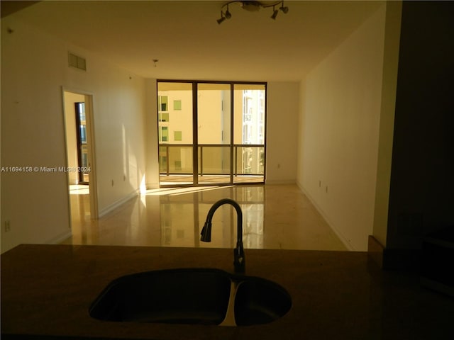 interior space featuring floor to ceiling windows and sink