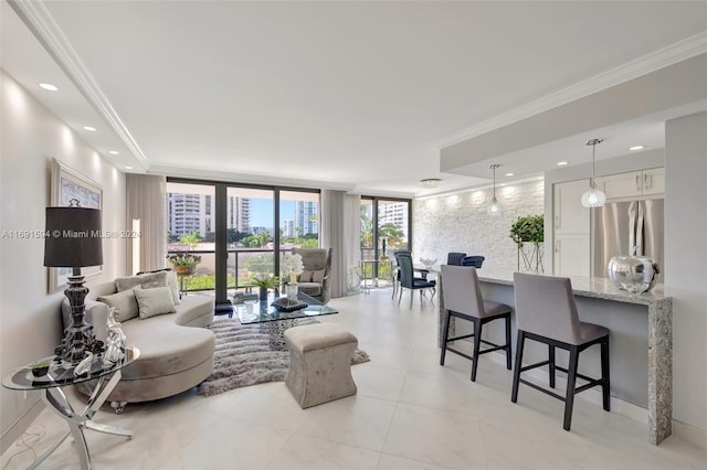 living room with crown molding and expansive windows