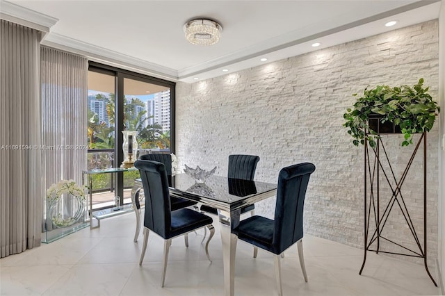 dining room with a wall of windows and crown molding