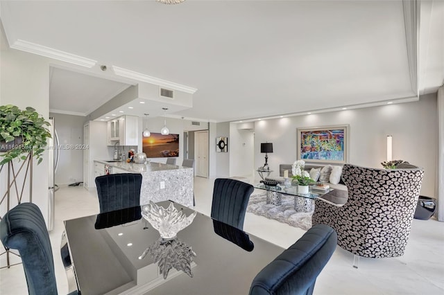 dining area featuring ornamental molding and sink