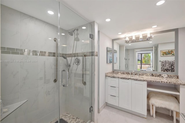 bathroom featuring vanity and an enclosed shower