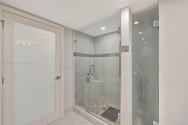 bathroom with a shower with shower door