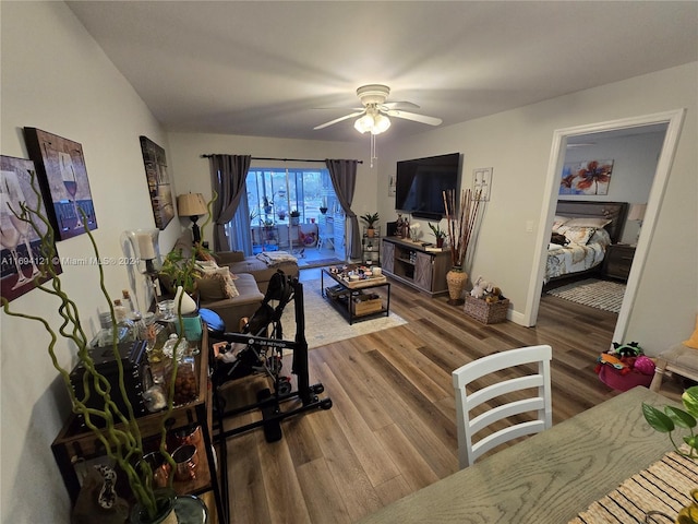 living room featuring hardwood / wood-style floors and ceiling fan