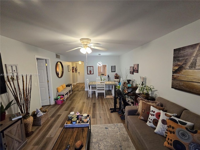 living room featuring hardwood / wood-style floors and ceiling fan