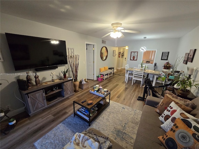 living room with hardwood / wood-style floors and ceiling fan