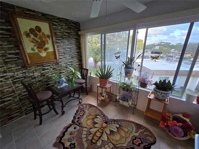 sunroom featuring ceiling fan