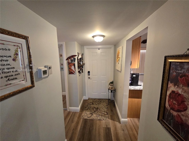 corridor with hardwood / wood-style floors