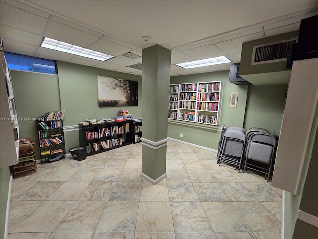 basement featuring a paneled ceiling