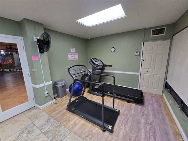 exercise room featuring light hardwood / wood-style floors