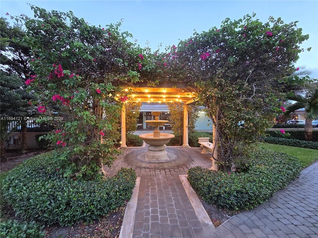 patio terrace at dusk featuring a pergola