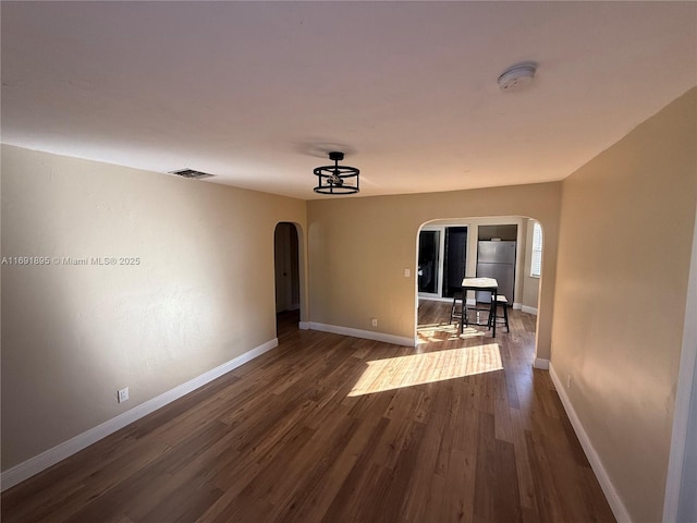 unfurnished room with dark hardwood / wood-style floors