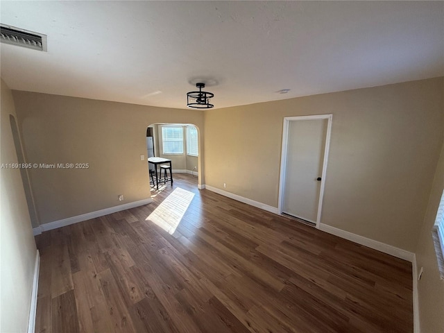 spare room featuring dark hardwood / wood-style floors