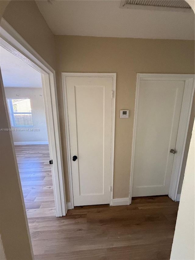 corridor featuring hardwood / wood-style floors