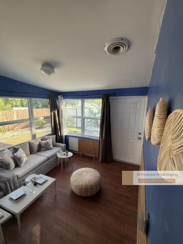 living room with radiator, vaulted ceiling, and dark hardwood / wood-style flooring