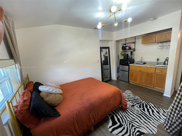 bedroom featuring lofted ceiling, dark hardwood / wood-style floors, and refrigerator