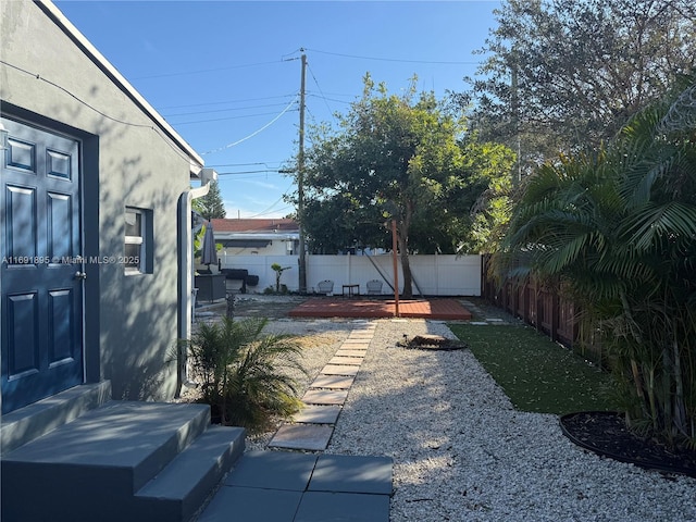 view of yard featuring a deck and a patio area