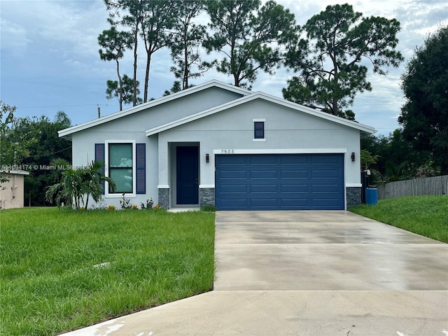 view of front of home with a garage and a front lawn