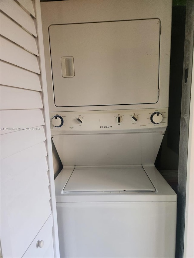 laundry room with stacked washer and clothes dryer