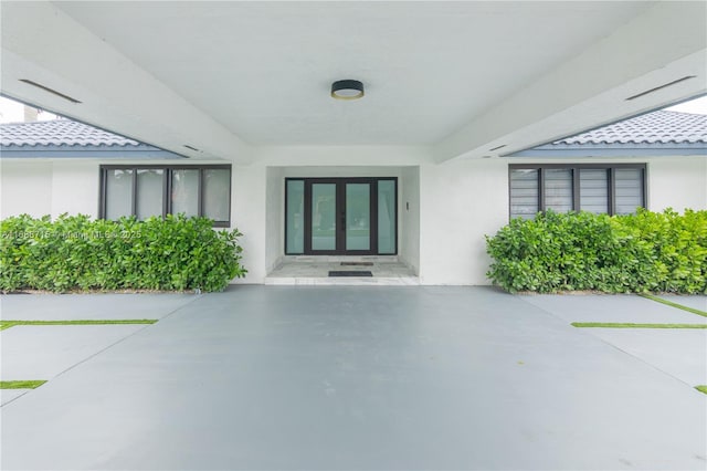 property entrance with a patio and french doors