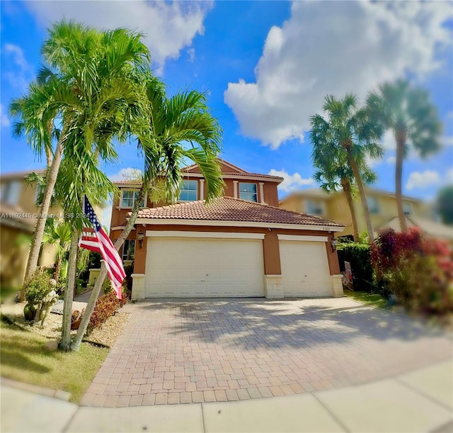 mediterranean / spanish house with a garage