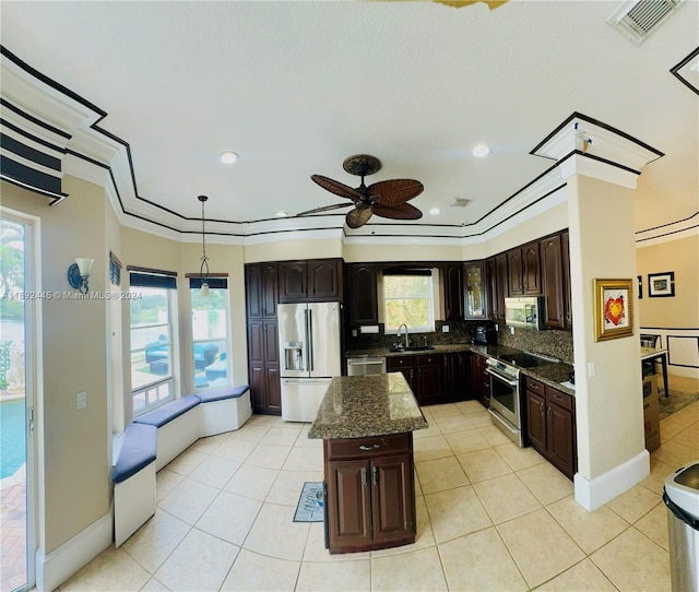 kitchen featuring appliances with stainless steel finishes, pendant lighting, and a healthy amount of sunlight