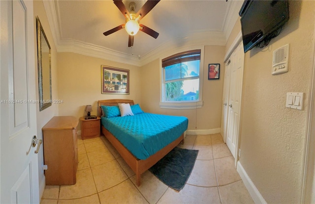 bedroom with ceiling fan, crown molding, and light tile patterned flooring