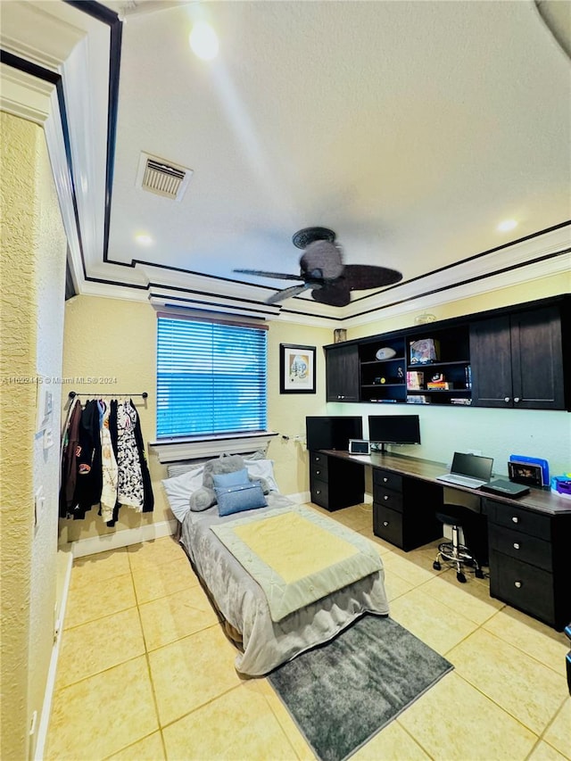 tiled bedroom featuring a textured ceiling, built in desk, and ceiling fan