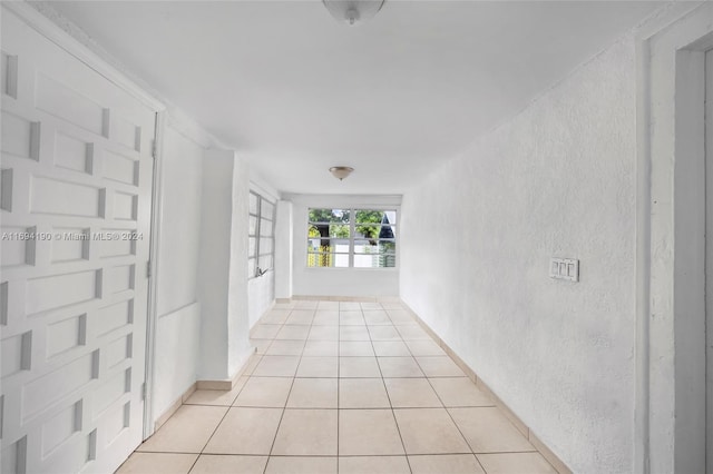 corridor featuring light tile patterned floors