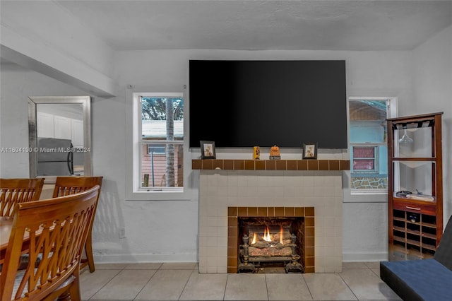 tiled living room with a tiled fireplace