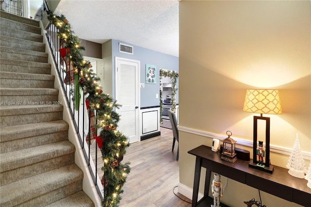 10710 La Placida Dr Unit 6-6, Coral Springs, FL 33065 - staircase featuring wood finished floors and a textured ceiling