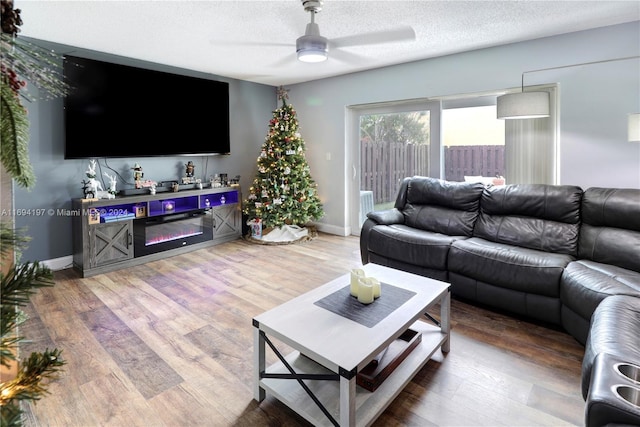10710 La Placida Dr Unit 6-6, Coral Springs, FL 33065 - living area with a ceiling fan, wood finished floors, baseboards, and a textured ceiling