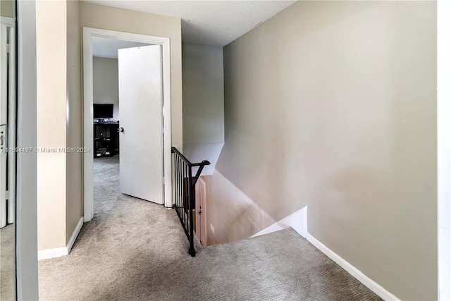 10710 La Placida Dr Unit 6-6, Coral Springs, FL 33065 - hallway featuring an upstairs landing, carpet floors, and baseboards