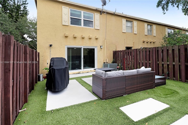 10710 La Placida Dr Unit 6-6, Coral Springs, FL 33065 - back of property featuring stucco siding, outdoor lounge area, a patio area, and central AC