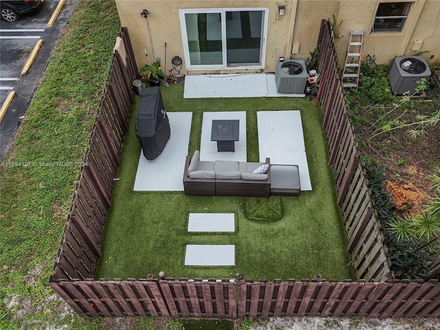 10710 La Placida Dr Unit 6-6, Coral Springs, FL 33065 - view of yard with central AC unit, outdoor lounge area, and a patio