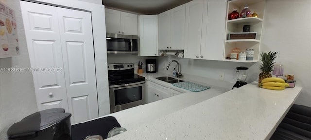 kitchen with white cabinets, sink, and appliances with stainless steel finishes