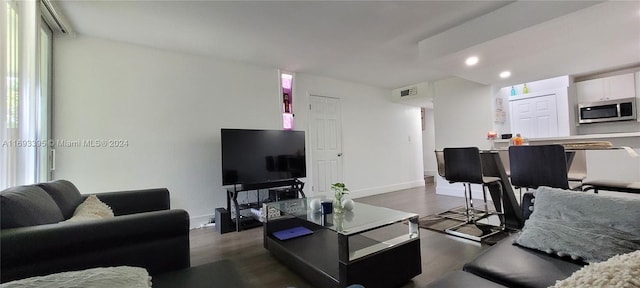 living room with dark hardwood / wood-style flooring