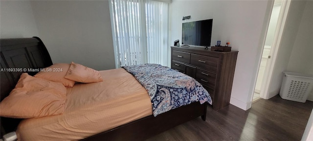 bedroom with dark hardwood / wood-style flooring