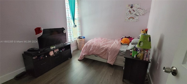 bedroom with dark hardwood / wood-style floors