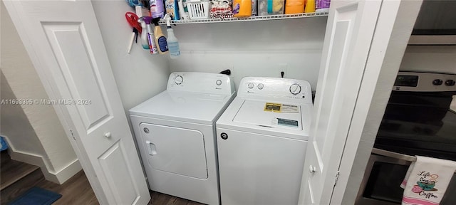 clothes washing area featuring dark hardwood / wood-style flooring and independent washer and dryer