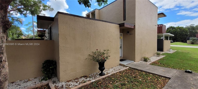 view of property exterior with a lawn