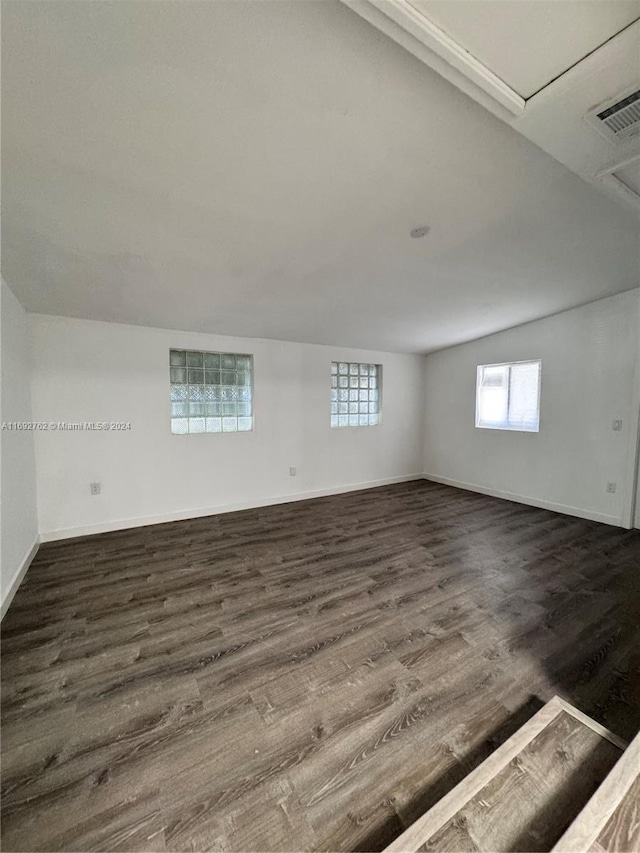 unfurnished room featuring dark wood-type flooring