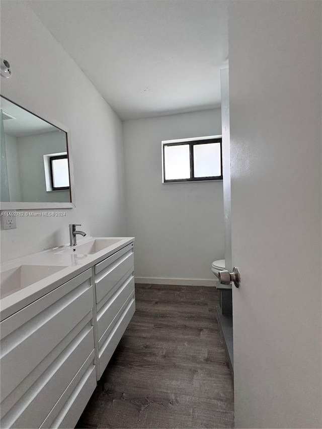 bathroom featuring hardwood / wood-style flooring, vanity, and toilet