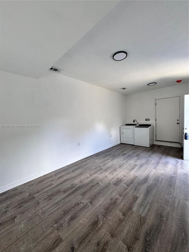 empty room featuring independent washer and dryer and wood-type flooring