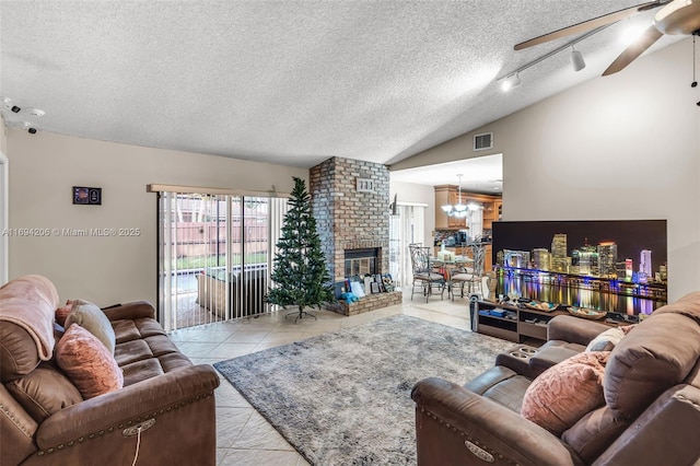 tiled living area featuring visible vents, ceiling fan, vaulted ceiling, a textured ceiling, and a brick fireplace