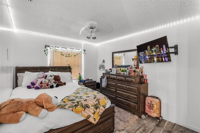 bedroom featuring a textured ceiling and wood finished floors